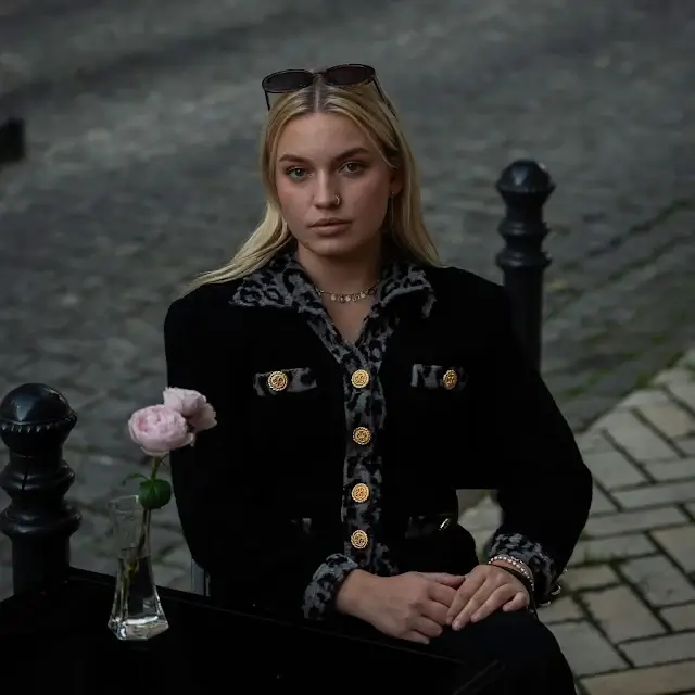 Kelsie Kimberlin sitting at a table in a cafe on the street